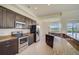 Modern kitchen with stainless steel appliances and granite countertops at 15124 Leipzig Cir, Port Charlotte, FL 33981