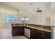 Kitchen with dark cabinetry, granite countertops and island with sink at 15124 Leipzig Cir, Port Charlotte, FL 33981