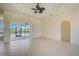 Living room with tile flooring, sliding glass doors and access to backyard at 15124 Leipzig Cir, Port Charlotte, FL 33981