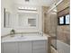 Bathroom featuring a tub and tiled shower, a large mirror, and ample lighting at 1912 Harbourside Dr # 603, Longboat Key, FL 34228