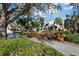 Fairway Bay condos showcasing lush landscaping, mature trees and white buildings with blue accents at 1912 Harbourside Dr # 603, Longboat Key, FL 34228