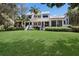 Spacious green lawn view of Fairway Bay condos showcasing the exterior with tropical landscaping at 1912 Harbourside Dr # 603, Longboat Key, FL 34228