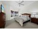 Spacious main bedroom featuring a ceiling fan, large windows, and neutral tones at 1912 Harbourside Dr # 603, Longboat Key, FL 34228