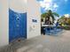 Outdoor pool shower with blue tile and lounge chairs nearby at 1912 Harbourside Dr # 603, Longboat Key, FL 34228