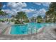 Community pool with surrounding landscaping and seating at 27475 Janzen Ct, Englewood, FL 34223