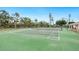 Community tennis court with surrounding landscape at 3330 Gulf Of Mexico Dr # 205D, Longboat Key, FL 34228