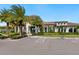 Community building with palm trees, landscaping, and ample parking at 4925 Surfside Cir, Bradenton, FL 34211