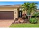 Landscaped front yard with palm trees and brick walkway at 4925 Surfside Cir, Bradenton, FL 34211