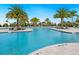 Large, refreshing community pool with palm trees and lounge chairs at 4925 Surfside Cir, Bradenton, FL 34211