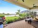 Spacious screened porch overlooking lake with wicker furniture at 4925 Surfside Cir, Bradenton, FL 34211