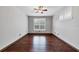 Bright bedroom featuring hardwood floors, plantation shutters, and a ceiling fan at 5581 Key West Pl # 5581, Bradenton, FL 34203