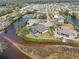 Aerial view of waterfront home with pool and private dock at 609 Colonial Bay Dr, Nokomis, FL 34275