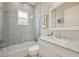 Modern bathroom with a soaking tub, glass shower, and marble vanity at 609 Colonial Bay Dr, Nokomis, FL 34275