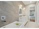 Elegant bathroom with double vanity, large mirror, and a modern soaking tub at 609 Colonial Bay Dr, Nokomis, FL 34275