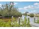 Tranquil waterfront view with private dock and lush greenery at 609 Colonial Bay Dr, Nokomis, FL 34275