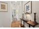 Bright hallway with hardwood floors and elegant wall art at 609 Colonial Bay Dr, Nokomis, FL 34275