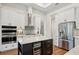 Kitchen island with wine cooler and stainless steel appliances at 609 Colonial Bay Dr, Nokomis, FL 34275