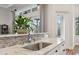 Modern kitchen sink with marble countertop and stainless steel faucet at 609 Colonial Bay Dr, Nokomis, FL 34275