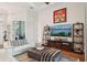 Living room with hardwood floors, white sofas, and a large flat screen TV at 609 Colonial Bay Dr, Nokomis, FL 34275