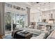 Light-filled living room features comfortable sofas, a large window, and pool access at 609 Colonial Bay Dr, Nokomis, FL 34275