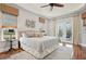 Spacious main bedroom with hardwood floors and access to a private balcony at 609 Colonial Bay Dr, Nokomis, FL 34275