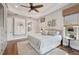 Main bedroom with hardwood floors, ceiling fan, and ensuite bathroom access at 609 Colonial Bay Dr, Nokomis, FL 34275