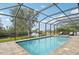 Relaxing screened-in pool with spa and water views at 609 Colonial Bay Dr, Nokomis, FL 34275