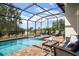 Inviting screened-in pool and patio area with seating at 609 Colonial Bay Dr, Nokomis, FL 34275