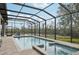 Inviting screened-in pool and spa overlooking a tranquil waterway at 609 Colonial Bay Dr, Nokomis, FL 34275