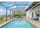 Inviting screened-in pool and spa with canal views at 609 Colonial Bay Dr, Nokomis, FL 34275