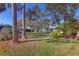 Landscaped backyard with lush greenery and mature trees at 6100 Green View Dr # 145, Sarasota, FL 34231