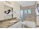 Bathroom with tub, granite vanity and decorative mirror at 6100 Greenview Dr # 145, Sarasota, FL 34231