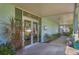 Inviting community entrance with glass doors and plants at 6100 Greenview Dr # 145, Sarasota, FL 34231