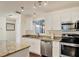 Modern kitchen with white cabinets and granite countertops at 6100 Green View Dr # 145, Sarasota, FL 34231