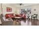 Living room with orange leather sofas and wood floors at 6100 Greenview Dr # 145, Sarasota, FL 34231