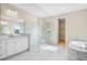 Modern bathroom with a large walk-in shower, double vanity, and soaking tub at 9153 Radiant Cir, Sarasota, FL 34241