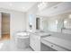 Elegant bathroom with marble finishes, a soaking tub, and a walk-in shower at 9153 Radiant Cir, Sarasota, FL 34241