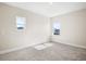 Bright bedroom with neutral walls and carpet, featuring two windows with natural light at 9153 Radiant Cir, Sarasota, FL 34241