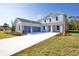 Two-story house with gray siding, three-car garage, and landscaped lawn at 9153 Radiant Cir, Sarasota, FL 34241