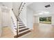 Elegant staircase with wooden steps and white railings leading to the second floor at 9153 Radiant Cir, Sarasota, FL 34241