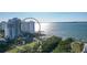 Aerial view of a waterfront high-rise condo with nearby park and water access at 988 Blvd Of The Arts # 915, Sarasota, FL 34236