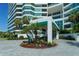 Condo building entrance with landscaped courtyard at 988 Blvd Of The Arts # 915, Sarasota, FL 34236