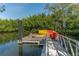 Wooden kayak dock with yellow and orange kayaks at 988 Blvd Of The Arts # 915, Sarasota, FL 34236