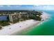 Aerial view of beachfront building and ocean at 19 Whispering Sands Dr # 1204, Sarasota, FL 34242