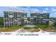 Two-building complex with a shared pool near the beach at 19 Whispering Sands Dr # 1204, Sarasota, FL 34242