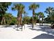 Two BBQ grills set amongst palm trees on a sandy area at 19 Whispering Sands Dr # 1204, Sarasota, FL 34242