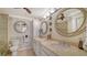 Spa-like bathroom with double vanity and marble finishes at 19 Whispering Sands Dr # 1204, Sarasota, FL 34242