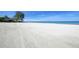 Expansive beachfront view with pristine white sand and clear waters at 19 Whispering Sands Dr # 1204, Sarasota, FL 34242