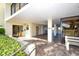 Building entrance with tiled floor, lush landscaping, and access to amenities at 19 Whispering Sands Dr # 1204, Sarasota, FL 34242