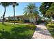 Attractive clubhouse with landscaping and a brick pathway at 19 Whispering Sands Dr # 1204, Sarasota, FL 34242